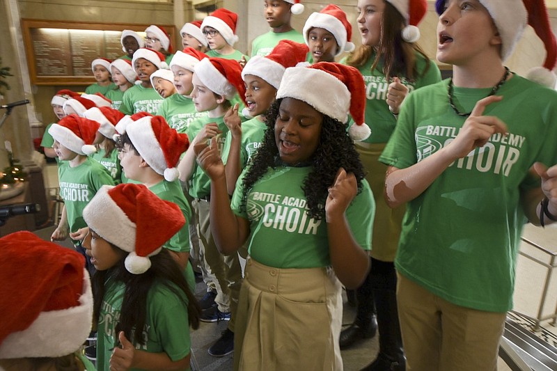 Latoria Battle, center, and Perrin Grimes, top right, sway and snap their fingers as they sing the Blitzen Boogie Monday with members of the Battle Academy choir during the first performance of the 34th annual Christmas at the Courthouse on Monday, Dec. 3, 2018.