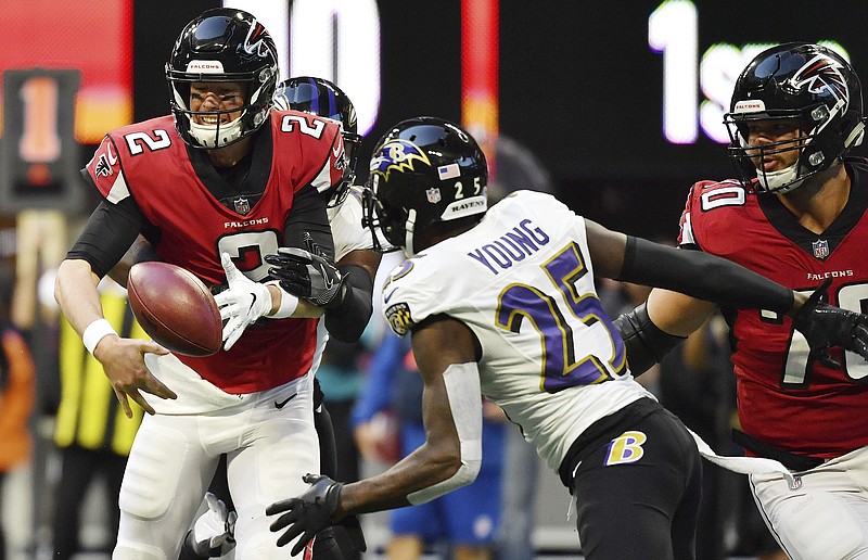 Atlanta Falcons quarterback Matt Ryan fumbles as Baltimore Ravens cornerback Tavon Young closes in during Sunday's game in Atlanta.