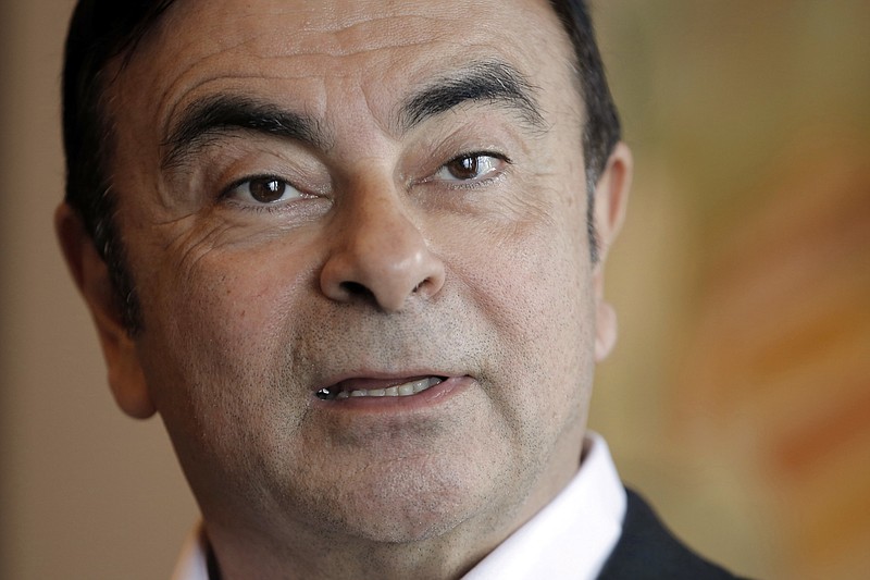 FILE - In this April 20, 2018, file photo, then Nissan Chairman Carlos Ghosn speaks during an interview in Hong Kong. One of the biggest mysteries surrounding the arrest of Nissan’s former chairman Carlos Ghosn is over how he allegedly could have underreported his income by millions of dollars for years and why the company is going after the suspected wrongdoing now. (AP Photo/Kin Cheung, File)