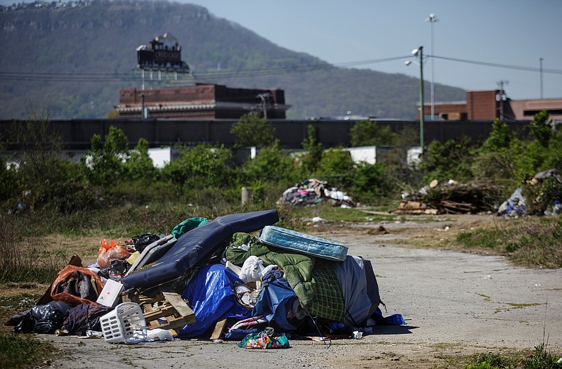 Piles of tents, sleeping bags, and trash are seen in the former site of a homeless encampment on city-owned property behind the municipal wellness center on East 11th Street on Thursday, April 12, 2018, in Chattanooga, Tenn. The camp's residents were removed from the site because the property is a toxic brownfield. Out of 130 residents counted in the camp, 80 have applied for housing through Chattanooga Housing Authority and 8 have been approved, according to Twitter posts by Mayor Andy Berke's deputy chief of staff Kerry Hayes.