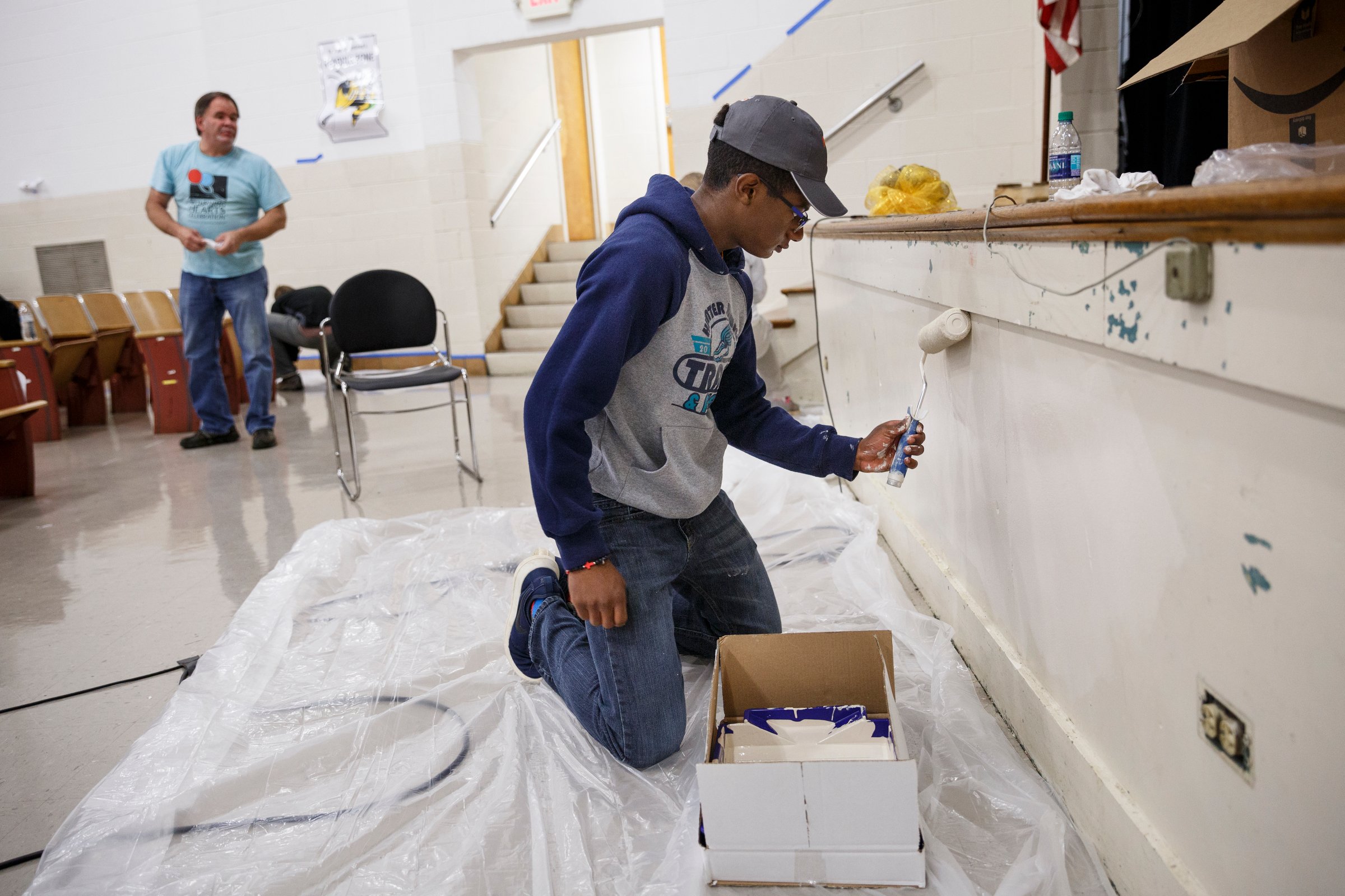 Jerrin Lowe paints the auditorium stage.