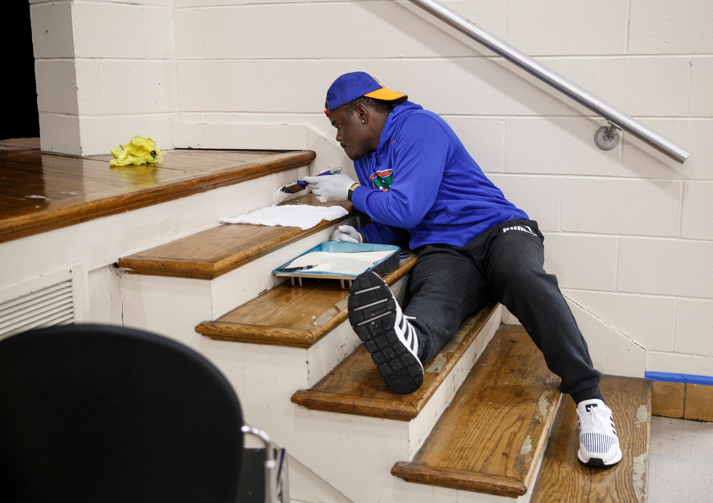 Justin Green paints the auditorium stairs