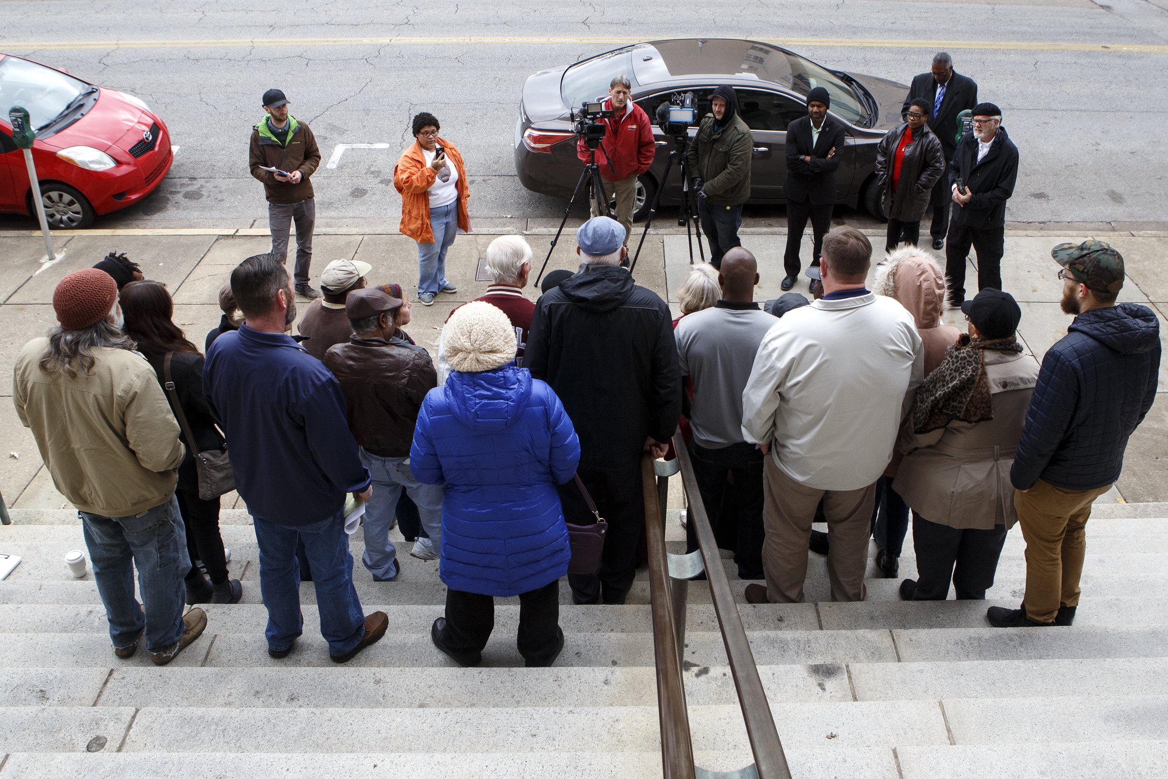 People gather on the steps of City Hall for a public statement by the Unity Group of Chattanooga about the former Harriet Tubman housing site on Tuesday, Dec. 4, 2018 in Chattanooga, Tenn.