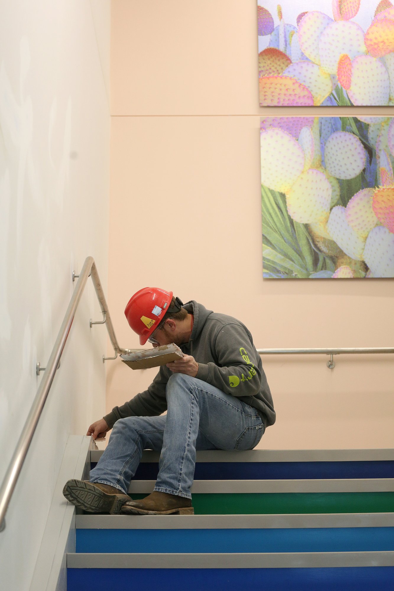 Staff photo by Erin O. Smith / Mitchell Geiger, a carpenter with McCarthy Building Companies, uses a filler to smooth out an area in the steps at Erlanger's new children's outpatient center Wednesday, Nov. 28, 2018, in Chattanooga, Tennessee. The facility is nearing completion.