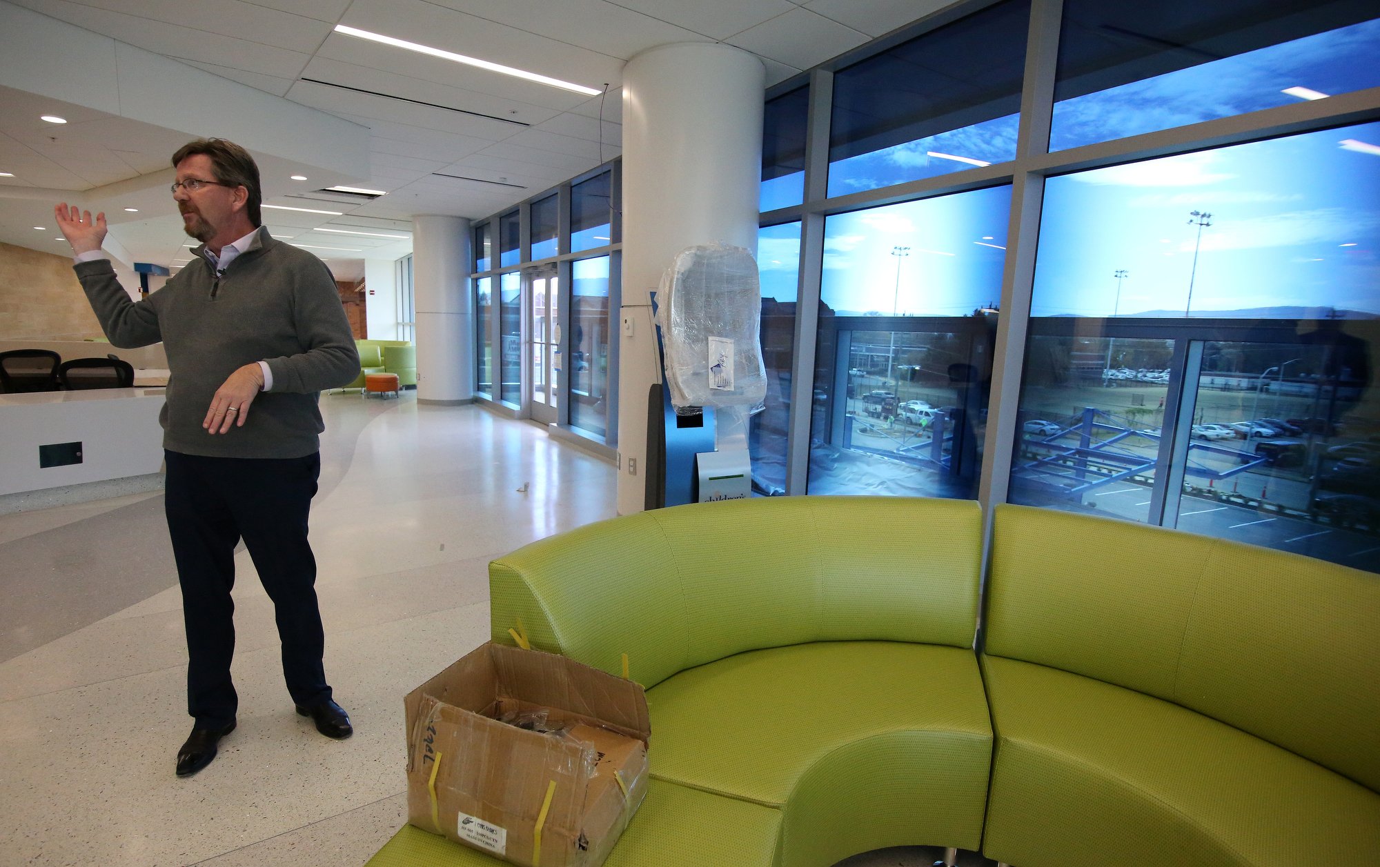 Staff photo by Erin O. Smith / Dan Luhrs, lead architect from HKS, talks about the design of the windows at Erlanger's new children's outpatient center Wednesday, Nov. 28, 2018, in Chattanooga, Tennessee. Instead of using blinds to block out direct sunlight, the center has windows that will darken and lighten depending on where the sun is in the sky.