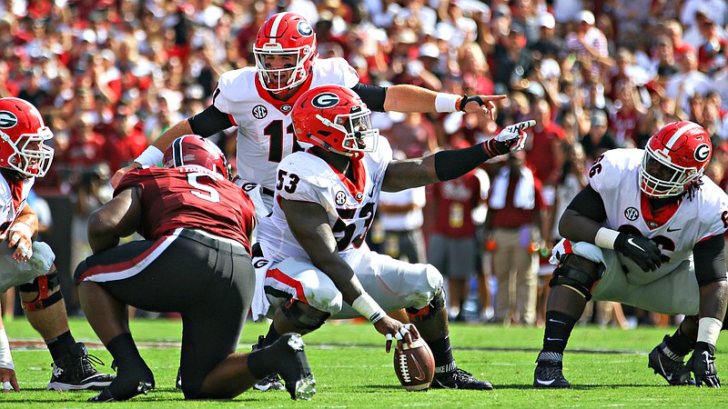 Georgia quarterback Jake Fromm (11) has excelled this season behind center Lamont Gaillard (53), guard Solomon Kindley (66) and the rest of the Bulldogs' offensive front.