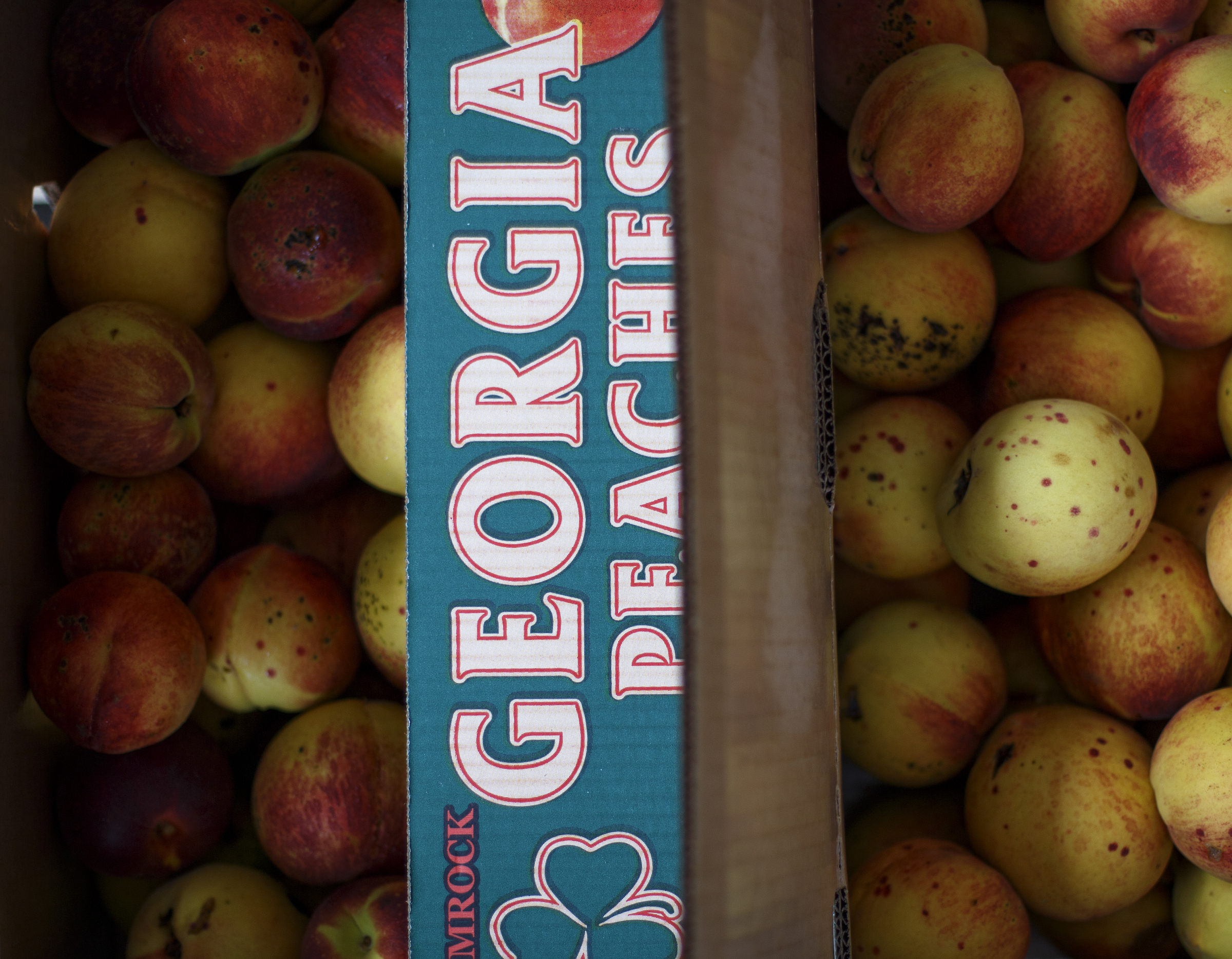 Boxes of Georgia peaches are seen at the Fitzgerald Fruit Farms booth during Chattanooga Market's Peach Festival event at the First Tennessee Pavilion on Sunday, July 22, 2018 in Chattanooga, Tenn.