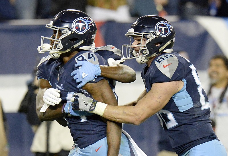 Tennessee Titans wide receiver Corey Davis, left, celebrates with tight end Anthony Firkser after Davis caught the game-winning touchdown against the New York Jets on Sunday in Nashville.
