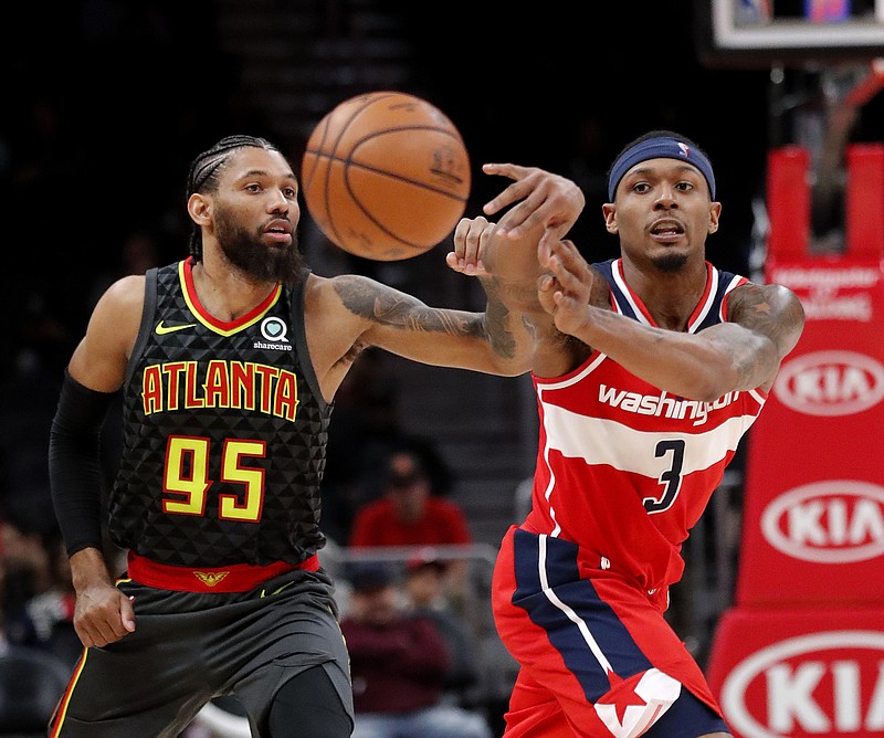 Washington Wizards guard Bradley Beal passes before Atlanta Hawks forward DeAndre' Bembry can steal the ball during Wednesday night's game in Atlanta, where Washington won 131-117.