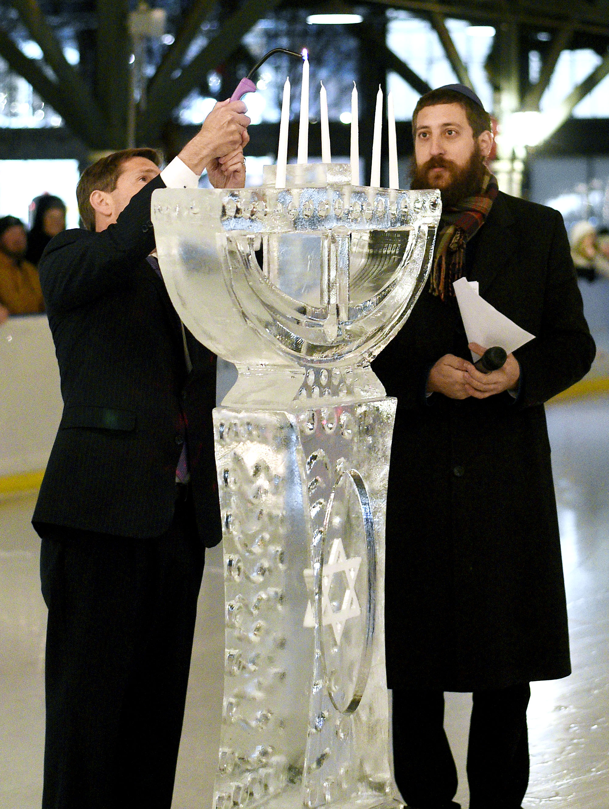 Congressman Chuck Fleischmann, left, lights the shamash candle on the ice Menorah as Rabbi Shaul Perlstein looks on. Chabad of Chattanooga celebrated Hanukkah with A Menorah topped car parade to the Choo Choo and the lighting of the Menorah at Ice on the Landing on December 6, 2018.