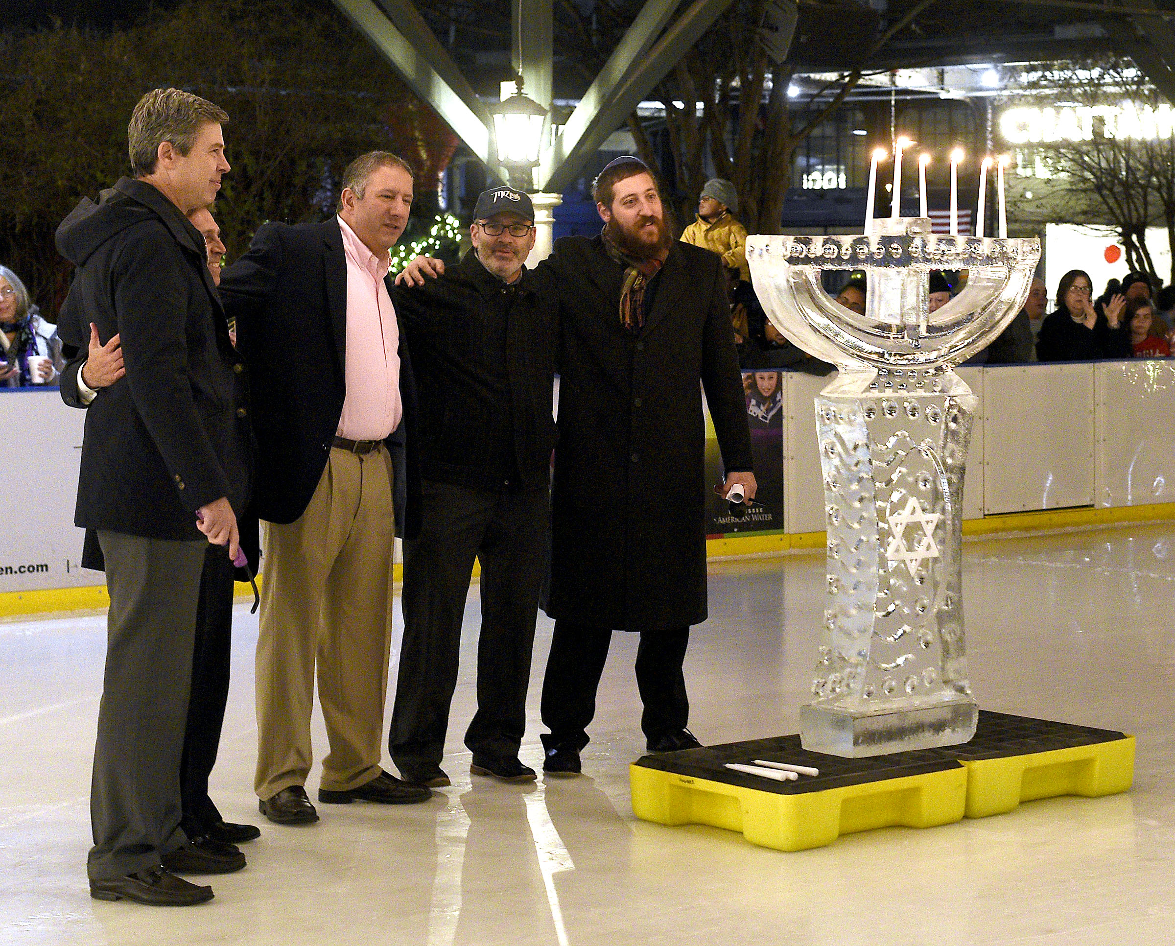 From left, Chattanooga Mayor Andy Berke, Congressman Chuck Fleischmann, Joesph Dzik, Rabbi Craig Lewis of the Mizpah Congreation and Rabbi Shaul Perlstein of Chabad of Chattanooga sing the blessing after the candles of the Menorah were lit. Thursday was the 5th day of the 8-day celebration so only five candles were lit. Chabad of Chattanooga celebrated Hanukkah with A Menorah topped car parade to the Choo Choo and the lighting of the Menorah at Ice on the Landing on December 6, 2018.