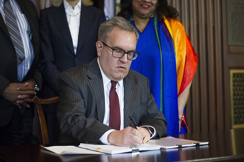 Acting EPA Administrator Andrew Wheeler signs an order withdrawing an Obama era emissions standards policy, at the EPA Headquarters in Washington, Thursday, Dec. 6, 2018. (AP Photo/Cliff Owen)

