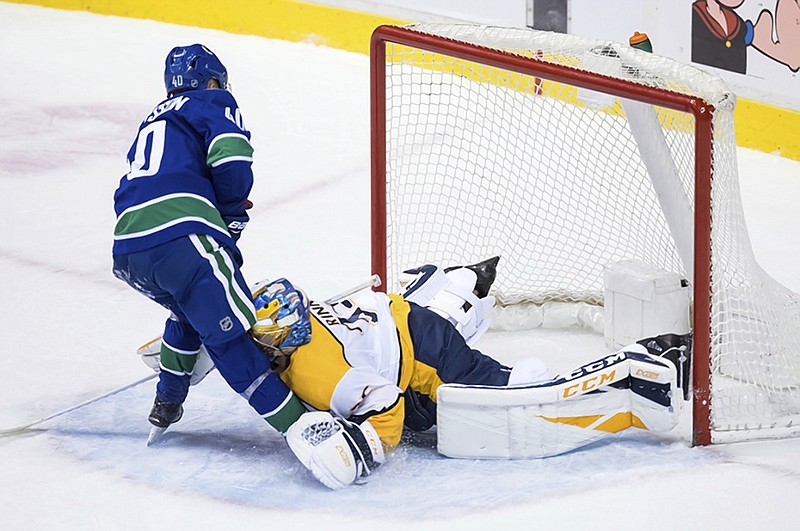 The Vancouver Canucks' Elias Pettersson scores on a penalty shot against Nashville Predators goalie Pekka Rinne during the second period of Thursday night's game in Vancouver.