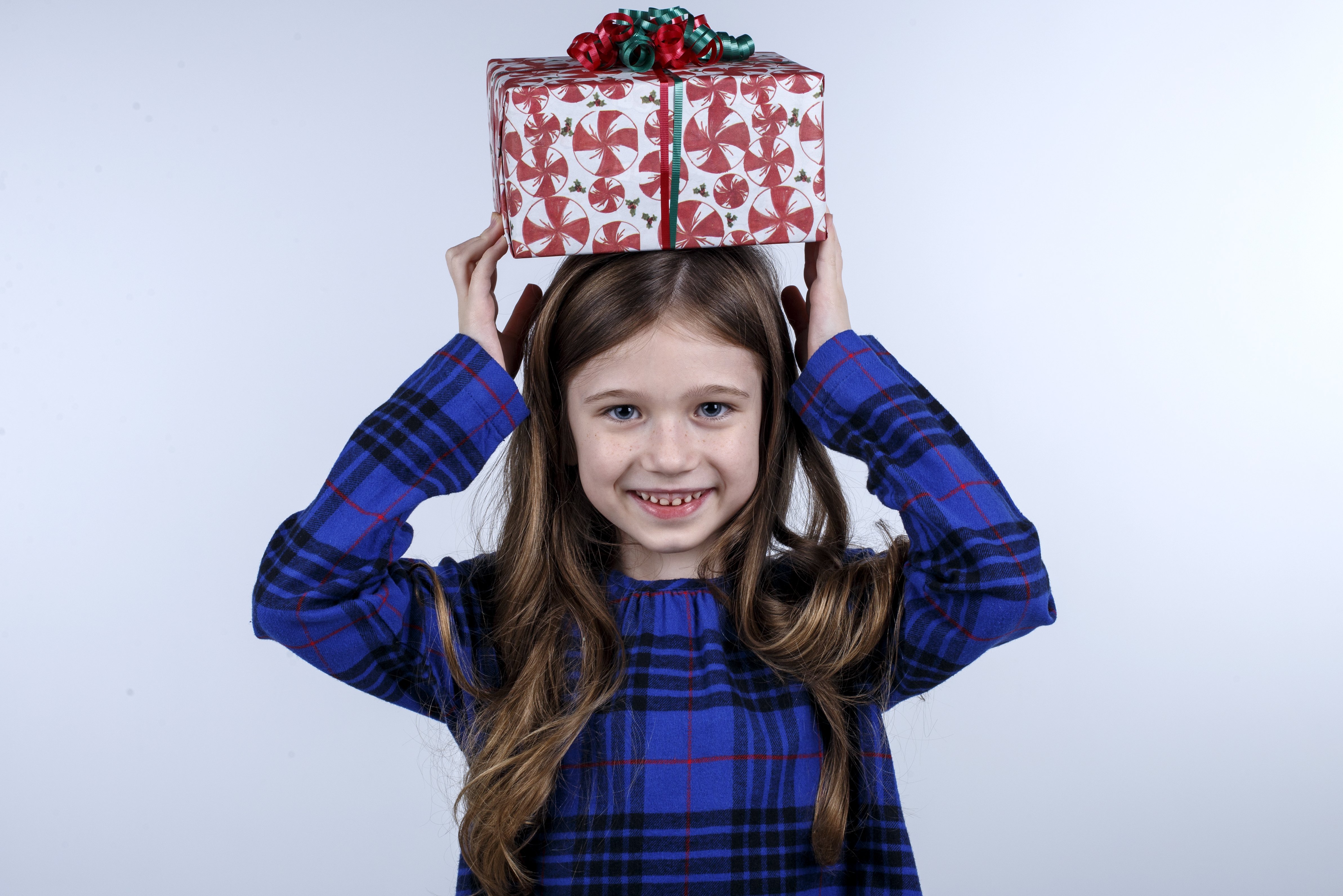 Seven-year-old Anna Shadrick, winner of the 2018 Lin C. Parker Gift Wrap Design Contest, poses with her design in the studio at the Times Free Press on Tuesday, Dec. 4, 2018 in Chattanooga, Tenn. (Staff photo by C.B. Schmelter)