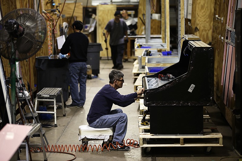 In this Thursday, Oct. 18, 2018, photo, workers build refrigerators at the Howard McCray's commercial refrigeration manufacturing facility in Philadelphia. This year, McCray has slashed its spending on large equipment in half and is leaving four jobs unfilled. "That's what the tariffs are doing to us," the company president said. (AP Photo/Matt Rourke)