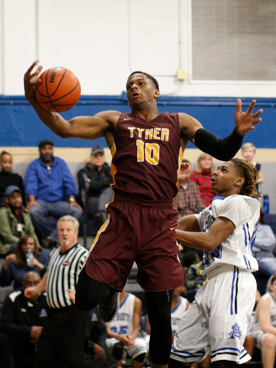 Tyner's Solomon Bridgeman rebounds over CSAS's Hollis Edwards during their prep basketball game at Chattanooga School for the Arts and Sciences on Friday, Dec. 7, 2018, in Chattanooga, Tenn.