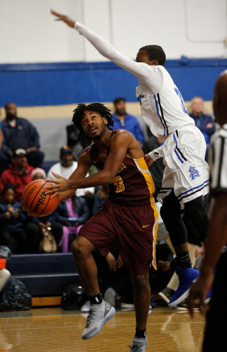 Tyner's Melique Hambrick shoots beneath CSAS's Cahlib Edwards during their prep basketball game at Chattanooga School for the Arts and Sciences on Friday, Dec. 7, 2018, in Chattanooga, Tenn.
