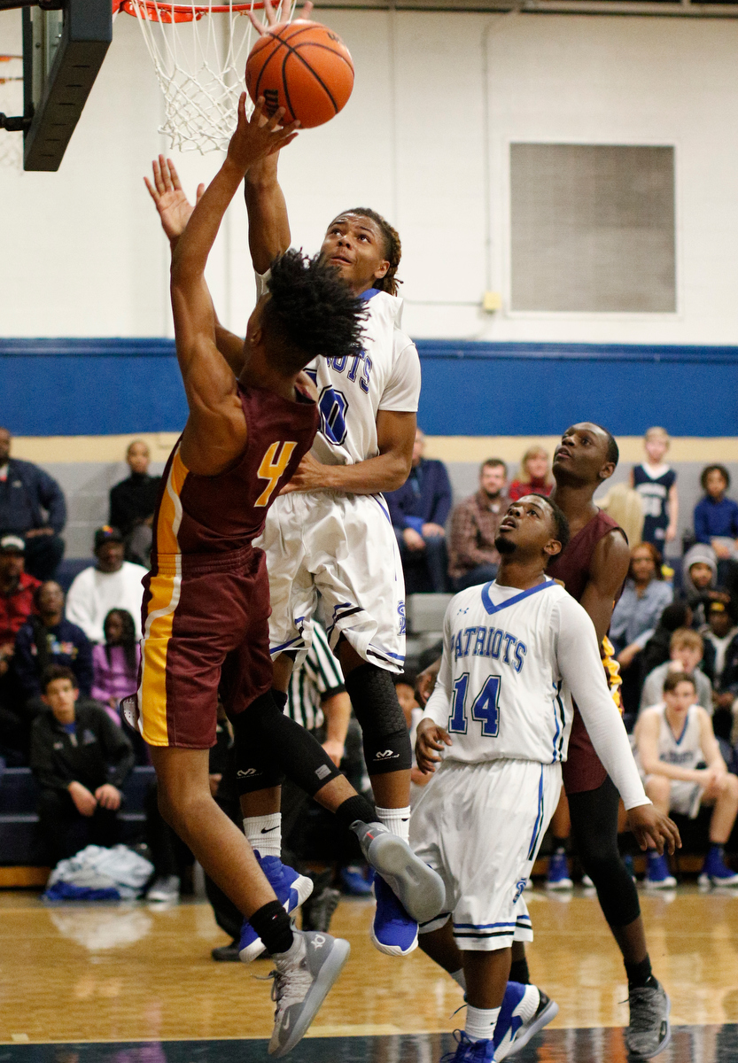 Tyner's Kameron Dozier (4) shoots into CSAS's Hollis Edwards during their prep basketball game at Chattanooga School for the Arts and Sciences on Friday, Dec. 7, 2018, in Chattanooga, Tenn.