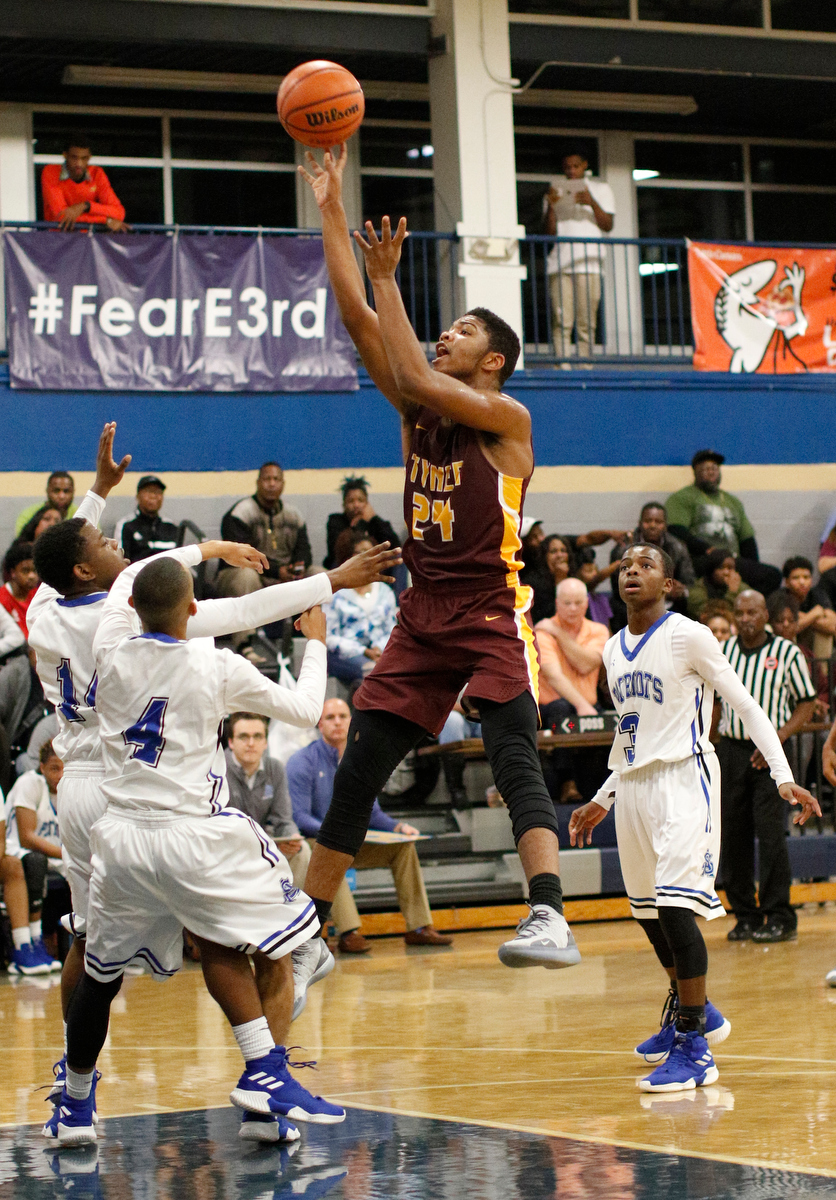 Tyner's Kobe Smith shoots over CSAS's Tony Orr (14), Chris Drake (4), and Cahlib Edwards (3) during their prep basketball game at Chattanooga School for the Arts and Sciences on Friday, Dec. 7, 2018, in Chattanooga, Tenn.