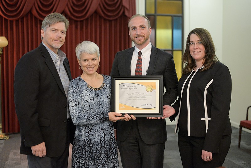 Wayne Chasteen and Mary McKinley of Christ First Church (left) present a C1 Community Leadership Award to James and Kristy Mullis of Wallis-Wilbanks Funeral Home. (Contributed photo)