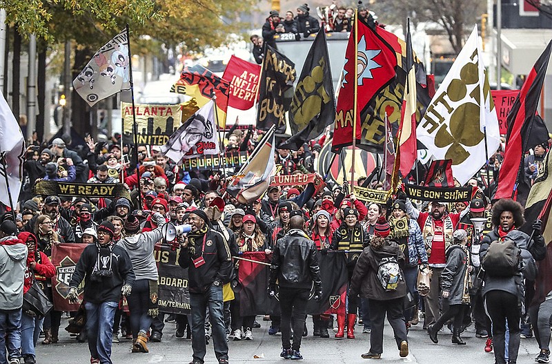 Fans march in celebration of the Atlanta United FC MLS team winning the championship in Atlanta, Monday, Dec. 10, 2018. Atlanta United defeated the Portland Timbers 2-0 on Saturday night. (John Spink/Atlanta Journal and Constitution via AP)/

