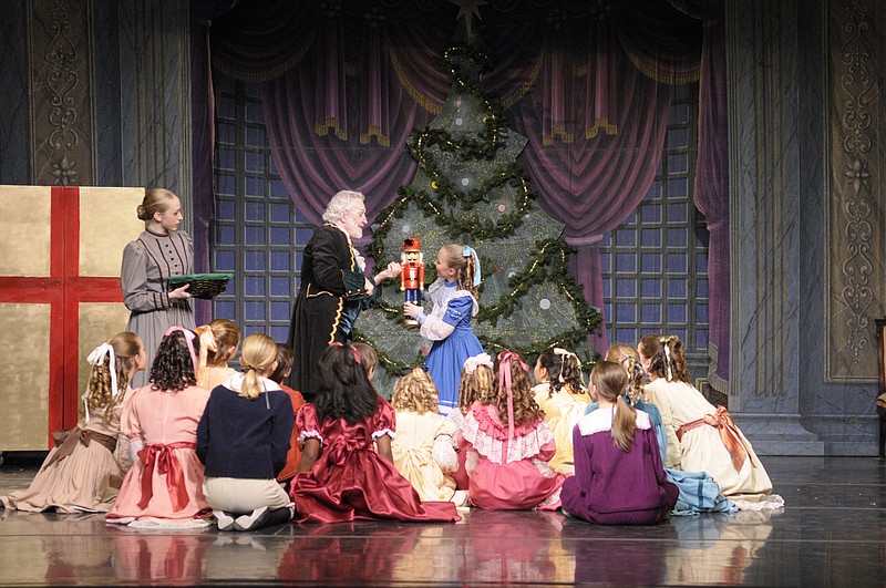 In a previous Ballet Tennessee performance of "The Nutcracker," the late Barry Van Cura played Herr Drosselmeyer, shown presenting a nutcracker to Reagon Sanborn as Clara. (Ballet Tennessee Photo)