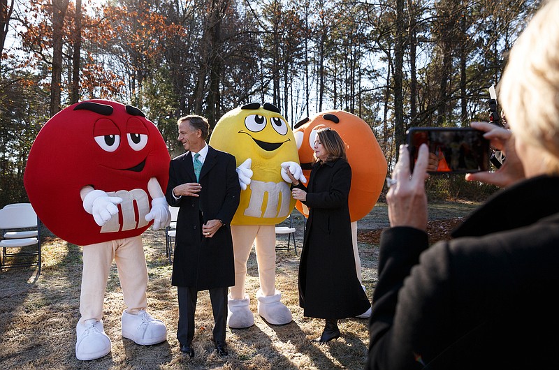 Gov. Bill Haslam, left, and his wife, Crissy, pose for photos with workers dressed as M&Ms, during a groundbreaking for the Mars Wrigley Confectionery Plant's expansion on Tuesday, Dec. 11, 2018, in Cleveland, Tenn. 