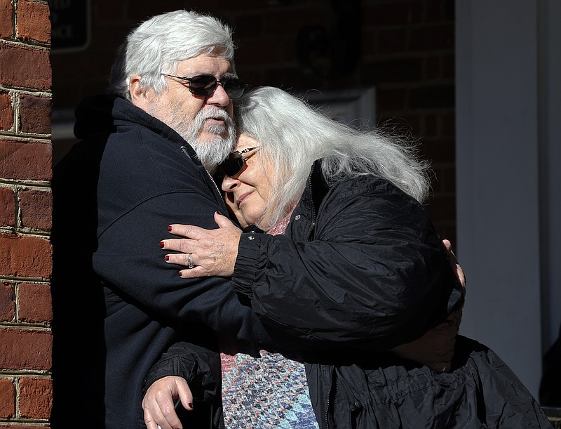 Susan Bro, mother of Heather Heyer, hugs her husband, Kent in front of Charlottesville Circuit Court after a jury recommended life plus 419 years for James Alex Fields Jr. for the death of Heyer as well as several other charges related to the Unite the Right rally in 2017 in Charlottesville, Va., Tuesday, Dec. 11, 2018. (AP Photo/Steve Helber)