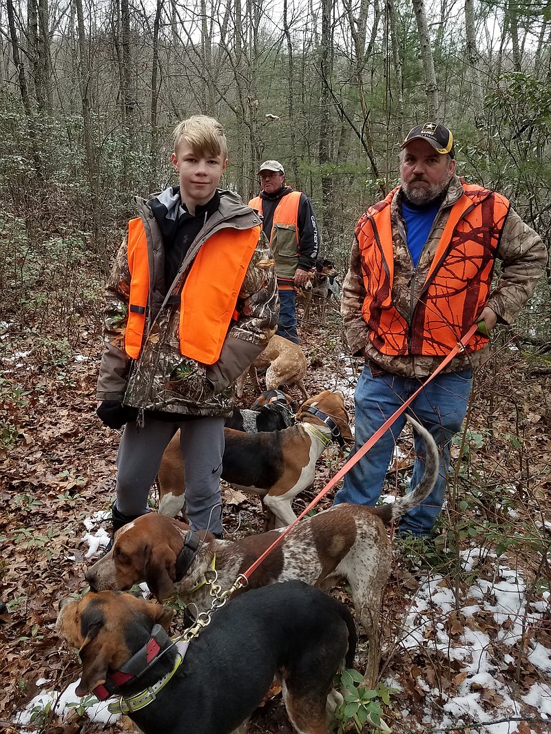 Young Camden Aho from South Carolina stands with bear hunters and dogs during the 2018 special USSA "dream-wish" hunt in West Virginia.