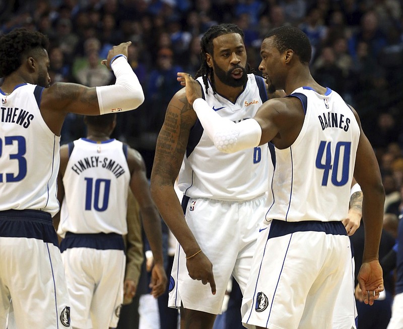 Dallas Mavericks guard Wesley Matthews (23) and center DeAndre Jordan (6) celebrate a shot in the fourth period by forward Harrison Barnes (40) against the Atlanta Hawks in the fourth period of an NBA basketball game, Wednesday, Dec. 12, 2018, in Dallas. (AP Photo/Richard W. Rodriguez)