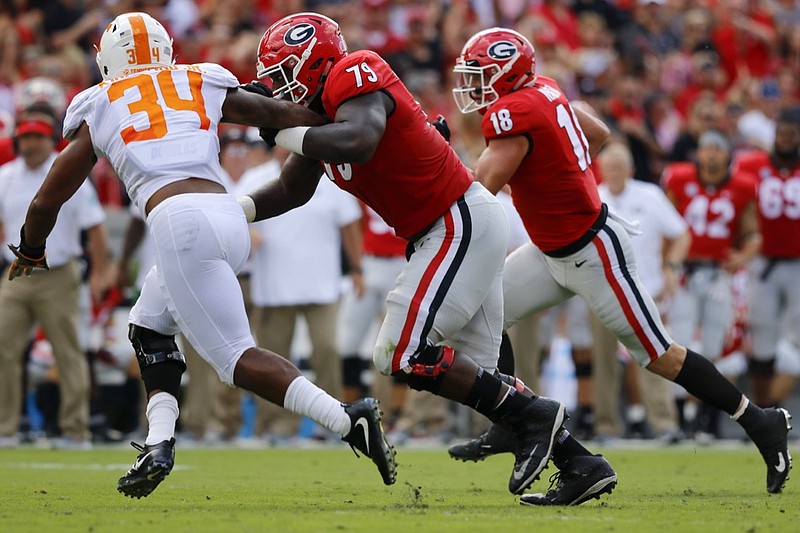 Georgia offensive lineman Isaiah Wilson (79) blocks Tennessee linebacker Darrin Kirkland Jr. (34) as tight end Isaac Nauta (18) returns a fumble for a touchdown during a Southeastern Conference football game at Sanford Stadium on Saturday, Sept. 29, 2018 in Athens, Ga.