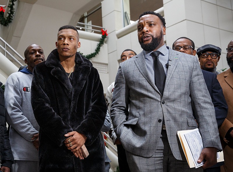 Attorney S. Lee Merritt, right, speaks next to his client Charles Toney Jr. during a news conference at the Hamilton County-Chattanooga Courts Building on Thursday, Dec. 13, 2018, in Chattanooga, Tenn. In the news conference, Merritt called for the firing of Hamilton County sheriff's deputies who were filmed punching and kicking Toney and for the district attorney's office to drop criminal charges against him.