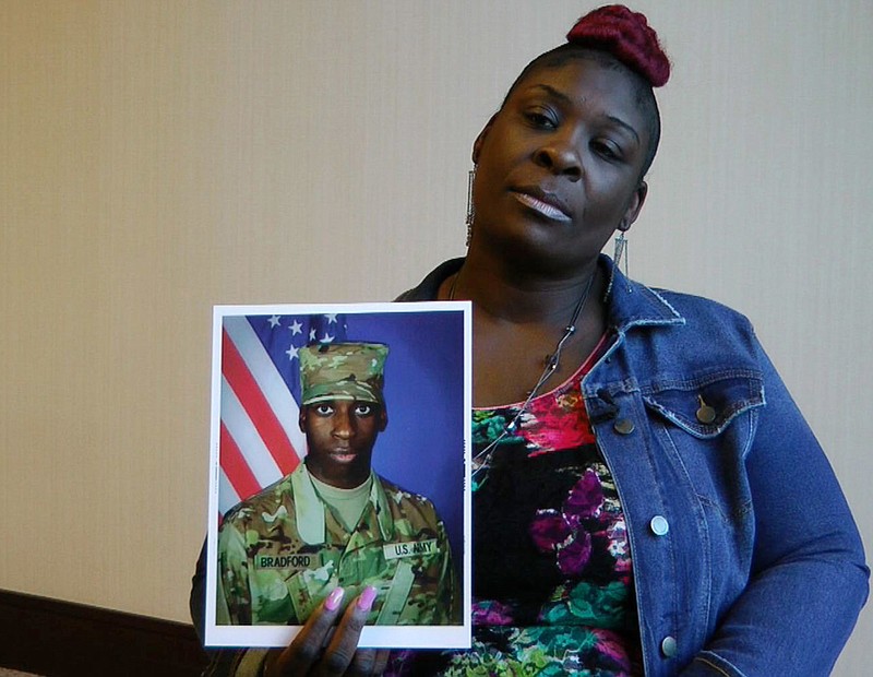 FILE - In this Nov. 27, 2018, file frame from video, April Pipkins holds a photograph of her deceased son, Emantic "EJ" Bradford Jr., during an interview in Birmingham, Ala. Alabama Attorney General Steve Marshall said Thursday, Dec. 13, that his office is taking over the investigation into the police killing of Emantic “EJ” Bradford Jr., a black man inside the state’s largest shopping mall on Thanksgiving night. (AP Photo/Jay Reeves, File)