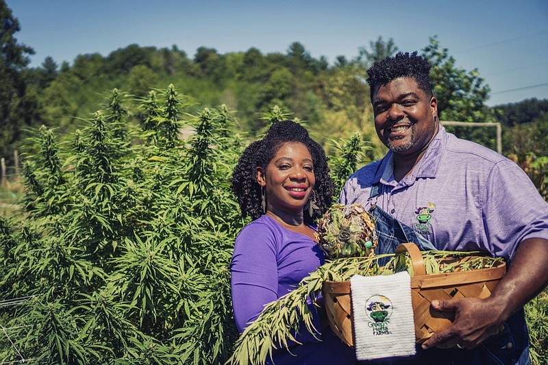 In this September 2018 photo provided by Clarenda "Cee" Stanley-Anderson, Stanley-Anderson and her husband, Malcolm Anderson Sr., pose for pictures of their hemp-farming business, Green Heffa Farms, Inc., in Liberty, N.C. Hemp is about to get the federal legalization that marijuana, its cannabis cousin, craves. That unshackling at the national level sets the stage for greater expansion in an industry seeing explosive growth through demand for CBDs, the non-psychoactive compound in hemp that many see as a way to better health. (Donald Rex Bishop/Green Heffa Farms, Inc. via AP)