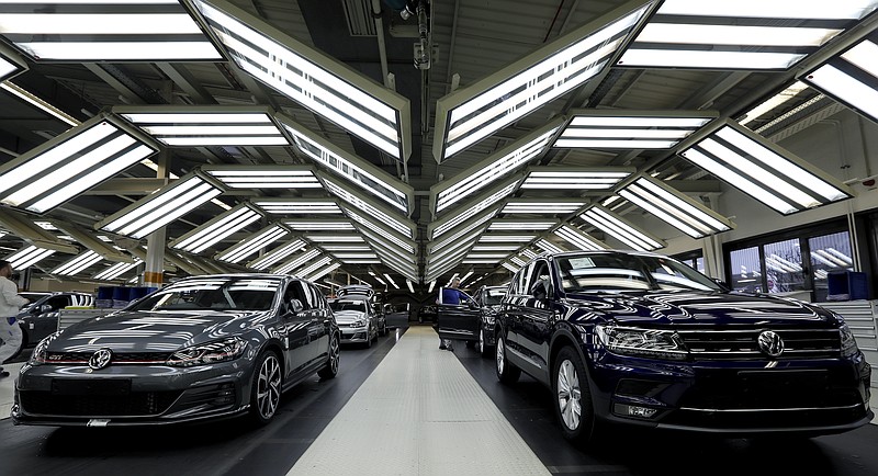 FILE - In this Thursday, March 8, 2018 file photo Volkswagen cars are pictured during a final quality control at the Volkswagen plant in Wolfsburg, Germany.  Automaker Volkswagen says it is on track for a new annual sales record despite troubles getting vehicles certified for new European emissions tests. (AP Photo/Michael Sohn, file)