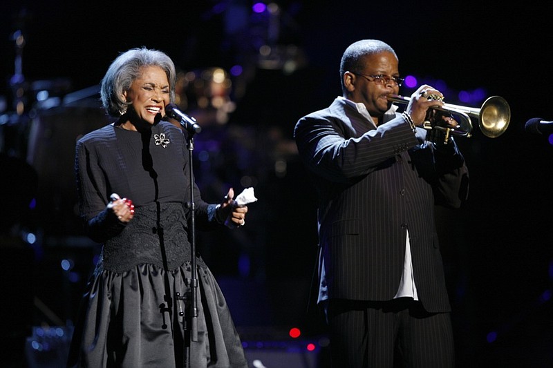 In this Oct. 28, 2007 file photo, Nancy Wilson, left, and Terence Blanchard, right, perform during an all-star tribute concert for Herbie Hancock, in Los Angeles. Grammy-winning jazz and pop singer Wilson has died at age 81. Her manager Devra Hall Levy tells The Associated Press late Thursday night, Dec. 13, 2018, that Wilson died peacefully after a long illness at her home in Pioneertown, a California desert community near Joshua Tree National Park. (AP Photo/Rene Macura, File)