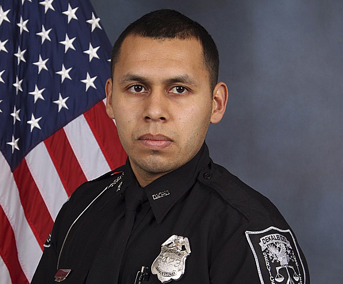 This undated handout photo released by the Dekalb County Police Department shows DeKalb County Police Officer Edgar Isidro Flores. Flores was gunned down after a traffic stop and foot chase east of Atlanta, Thursday, Dec. 13, 2018. (Dekalb County Police Department via AP)