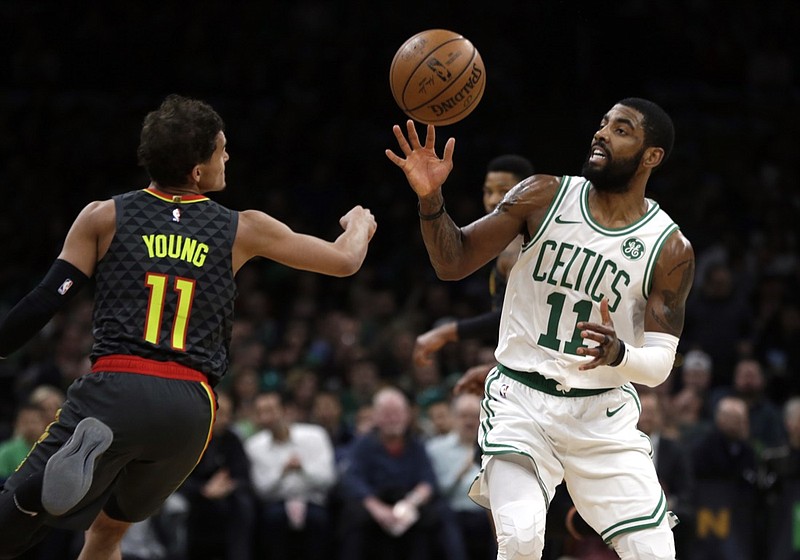 Boston Celtics guard Kyrie Irving, right, steals the ball from Atlanta Hawks guard Trae Young, left, in the first quarter of their game Friday night in Boston.