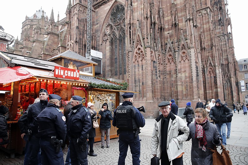 French police officers patrol outside the cathedral as the Christmas market reopens Friday in Strasbourg, eastern France.