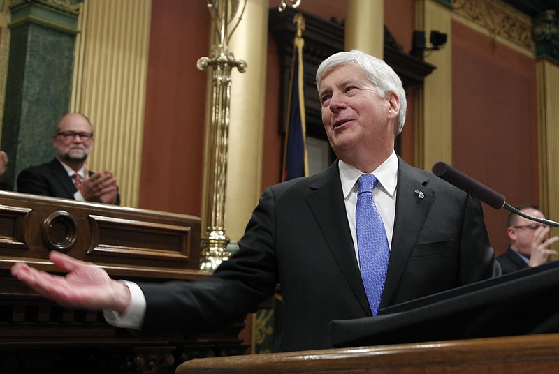 FILE - In this Jan. 23, 2018, file photo, Michigan's Republican Gov. Rick Snyder delivers his final State of the State address at the state Capitol in Lansing, Mich. Snyder signed laws on Friday, Dec. 14, 2018, to significantly scale back citizen-initiated measures to raise Michigan's minimum wage and require paid sick leave for workers, finalizing an unprecedented Republican-backed legislative maneuver that opponents vowed to challenge in court. (AP Photo/Al Goldis, File)