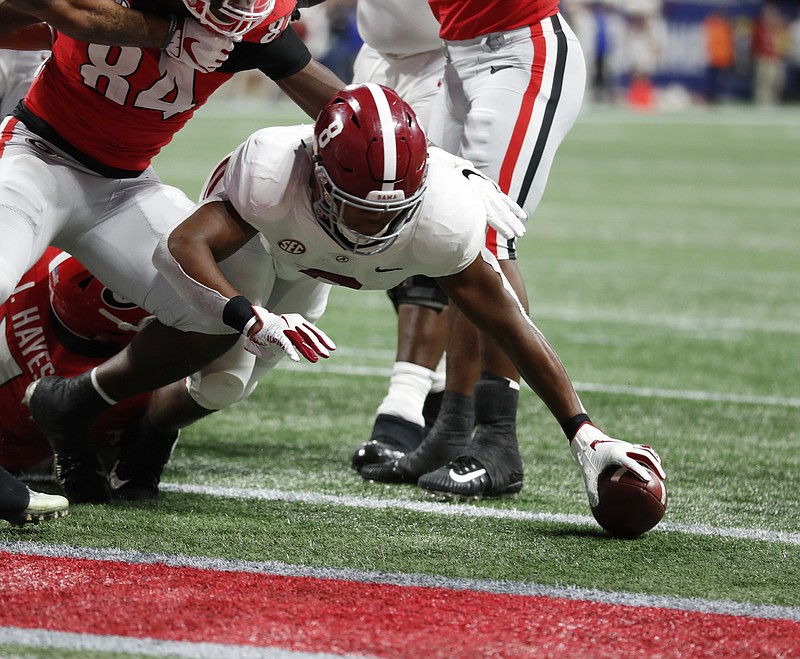 Alabama junior running back Josh Jacobs reaches across the goal line to score one of his two touchdowns in the Crimson Tide's 35-28 triumph over Georgia in the SEC championship game on Dec. 1.