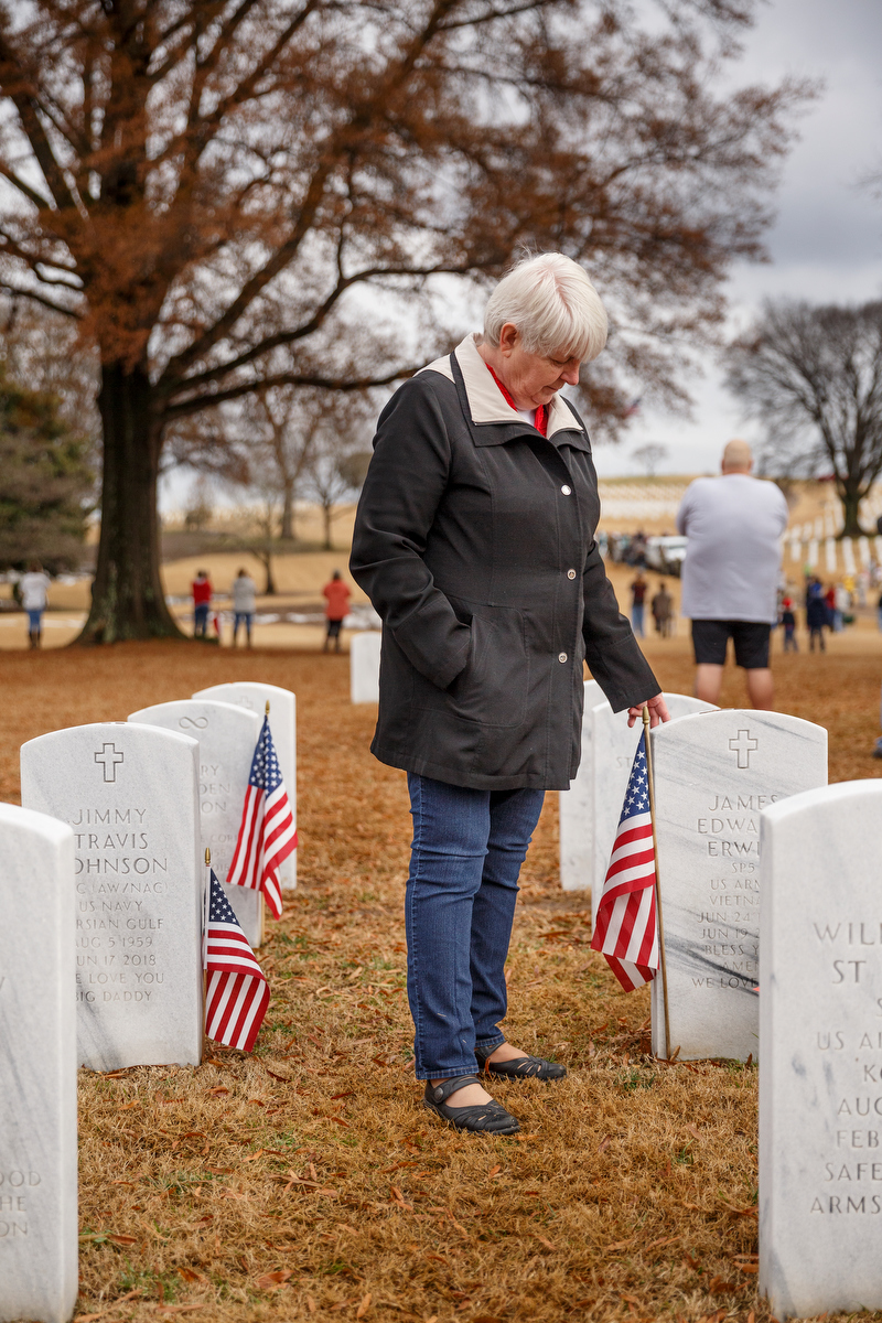 Staff photo by Doug Strickland / Andrew Erwin stands near the grave of her husband, James Erwin, during a memorial ceremony at the Chattanooga National Cemetery on Saturday, Dec. 15, 2018, in Chattanooga, Tenn. Thousands of volunteers turned out to lay wreaths on graves at the cemetery which were donated by the Worcester Wreath Company through the Wreaths Across America program, which supplies wreaths to national cemeteries across the country.