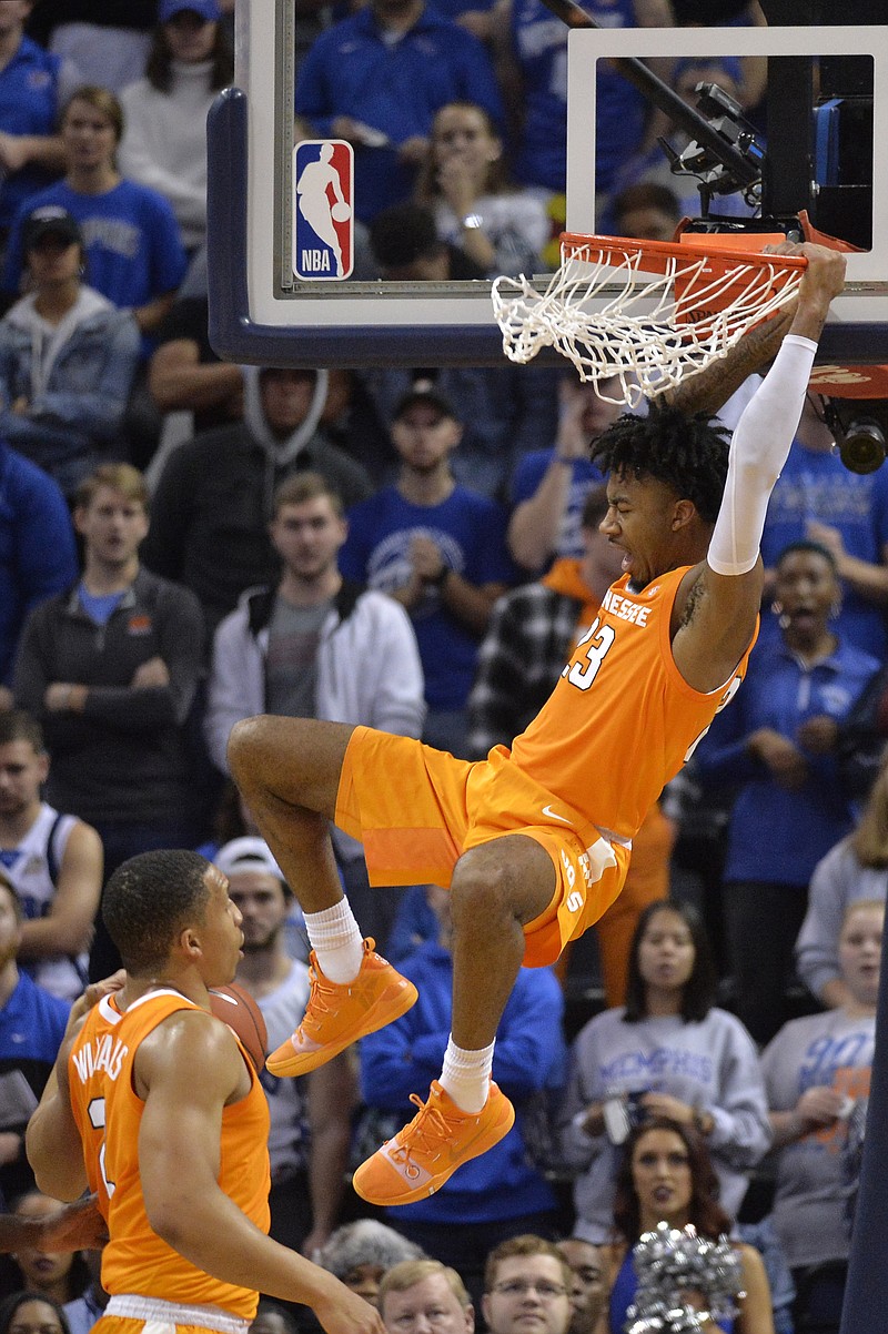 Tennessee guard Jordan Bowden hangs from the rim after dunking the ball in the first half of the Vols' 102-92 win Saturday at Memphis. Bowden had 12 points and six assists in the game.