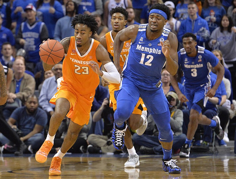 AP photo by Brandon Dill / Tennessee guard Jordan Bowden dribbles ahead of Memphis forward Victor Enoh during a December 2018 game in Memphis.