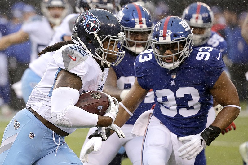 Tennessee Titans running back Derrick Henry carries the ball as New York Giants middle linebacker B.J. Goodson moves in for the tackle during the first half of Sunday's game in East Rutherford, N.J.