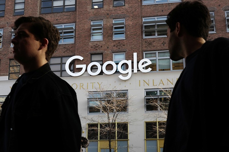 FILE - In this Dec. 4, 2017, file photo, people walk by Google offices in New York. Google is spending more than $1 billion to expand operations in New York City. Ruth Porat, senior vice president and chief financial officer at Google and Alphabet, said in a blog post Monday, Dec. 17, 2018, that Google is creating a more than 1.7 million square-foot campus that includes lease agreements along the Hudson River in lower Manhattan. (AP Photo/Mark Lennihan, File)