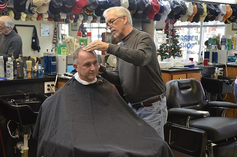 Eugene Ward gives Chattanooga firefighter Pat O'Brien a haircut at Red Bank Barber Shop.