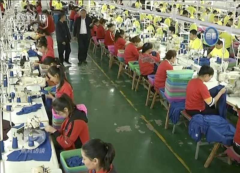 FILE - In this file image from undated video footage run by China's CCTV via AP Video, Muslim trainees work in a garment factory at the Hotan Vocational Education and Training Center in Hotan, Xinjiang, northwest China. China's state broadcaster CCTV aired the report Tuesday, Oct. 16, 2018, on the so-called vocational education and training center, with Muslim trainees telling the camera how they have been saved from dangerous and poor lives and how grateful they are to the authorities. (CCTV via AP Video, File)

