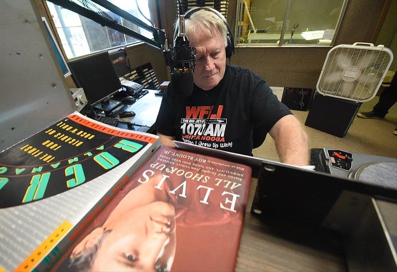 Longtime radio personality Gene Lovin works live on air Thursday at WFLI, the AM radio staple in Lookout Valley.