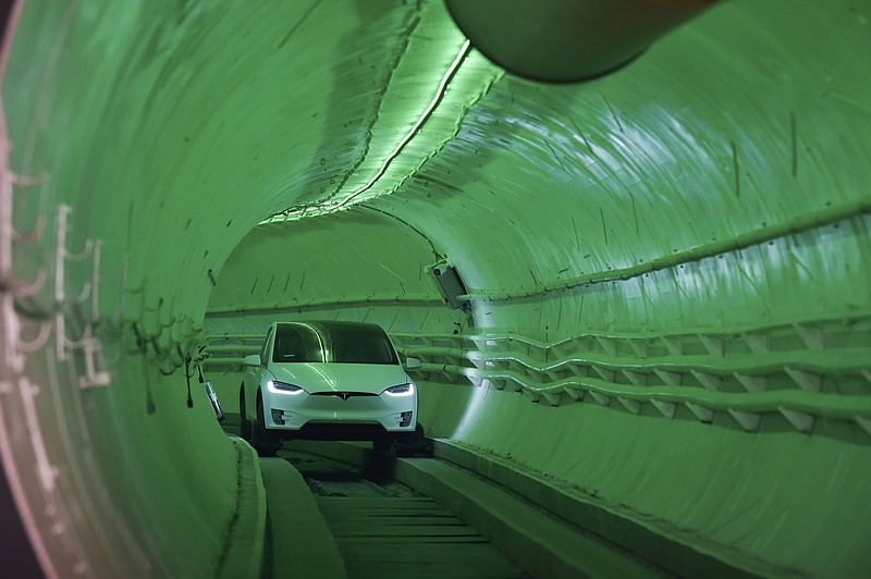 Elon Musk, co-founder and chief executive officer of Tesla Inc., arrives in a modified Tesla Model X electric vehicle during an unveiling event for the Boring Company Hawthorne test tunnel in Hawthorne, Calif., on Tuesday, Dec. 18, 2018. Musk unveiled his underground transportation tunnel on Tuesday, allowing reporters and invited guests to take some of the first rides in the revolutionary albeit bumpy subterranean tube — the tech entrepreneur's answer to what he calls "soul-destroying traffic." (Robyn Beck/Pool Photo via AP)